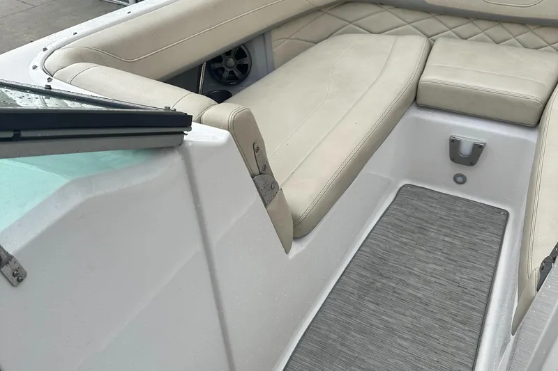 Slide: The Image of 2019 Regal 26 OBX boat interior with beige seating and gray flooring. - 8