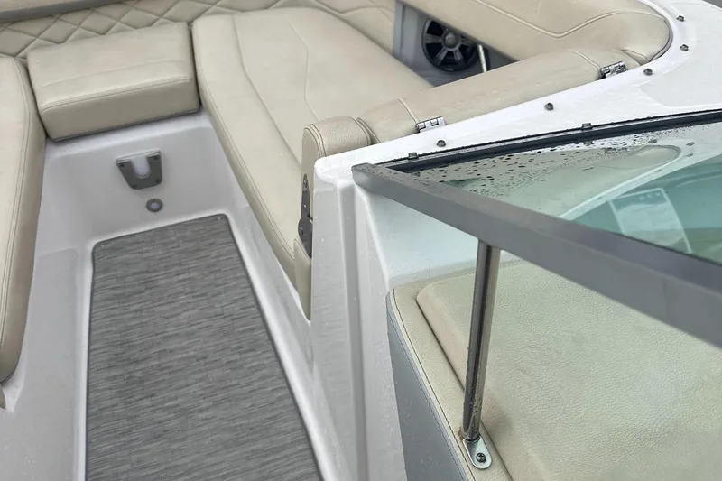 Slide: The Image of 2019 Regal 26 OBX boat interior with beige seating and grey flooring. - 9