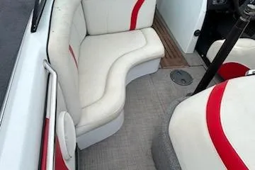 Slide: The Image of 1998 Supra Legacy boat interior with white and red seating. - 13