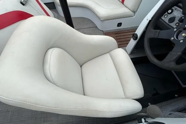 Slide: The Image of 1998 Supra Legacy boat interior with white and red seating, steering wheel visible. - 9