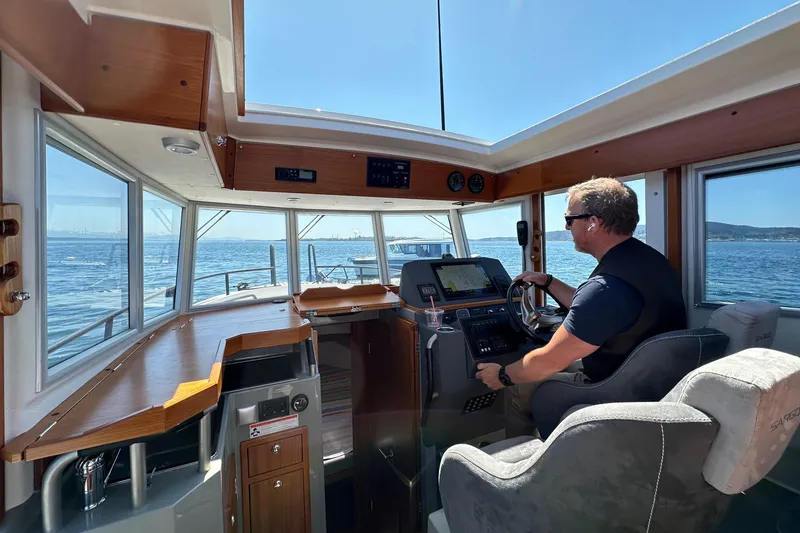 Slide: The Image of Man steering 2020 Sargo 31 boat on open water. - 15