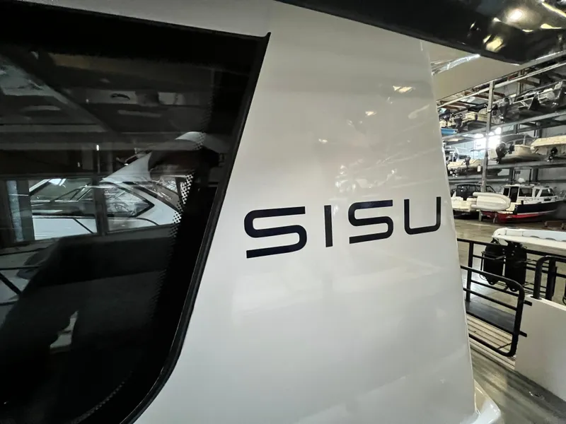 Slide: The Image of Sargo 31 2020 boat with SISU text on the side in a marina. - 31
