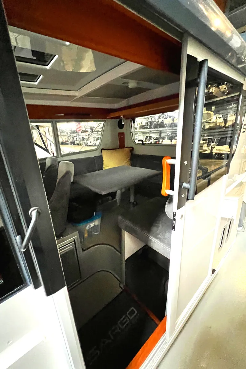 Slide: The Image of Interior of a 2020 Sargo 31 boat with seating and table. - 32