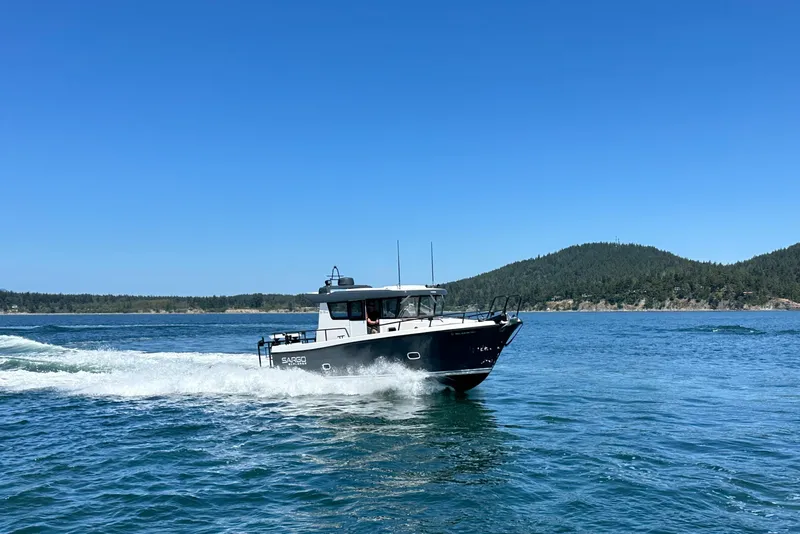 Slide: The Image of 2020 Sargo 31 boat cruising on a clear blue lake with forested hills in the background. - 4