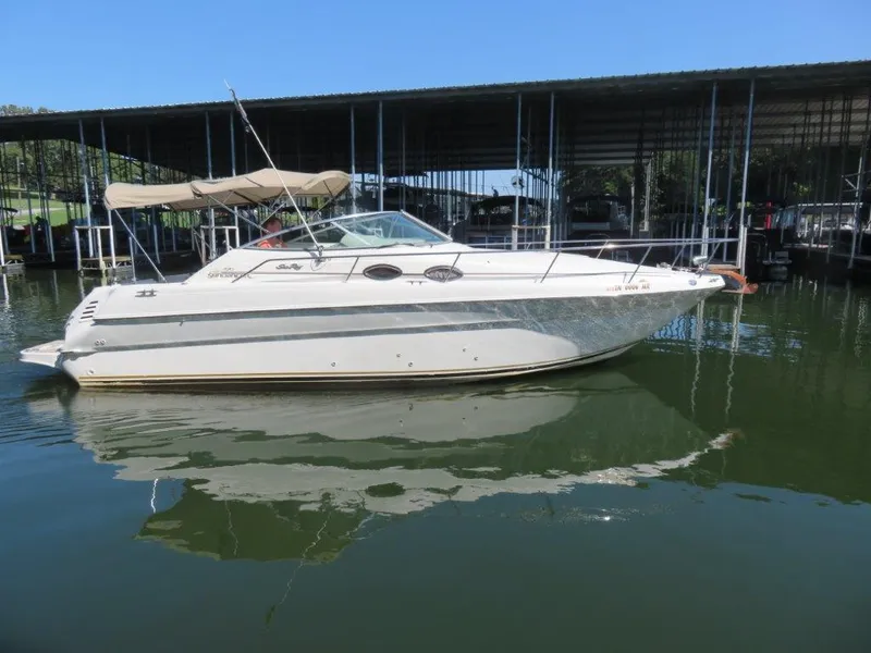 The Image of 2000 Sea Ray 270 DANCER boat docked on calm water under a clear blue sky. - 0