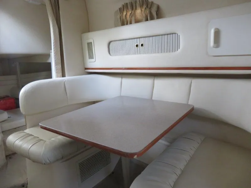 Slide: The Image of Interior of 2000 Sea Ray 270 DANCER with white seating and table. - 6