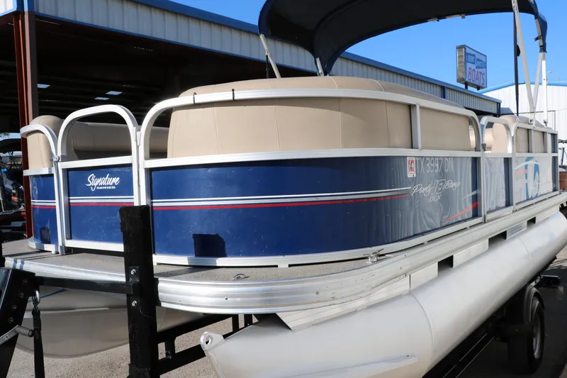 Slide: The Image of 2016 Sun Tracker Party Barge 18 DLX pontoon boat on trailer. - 10
