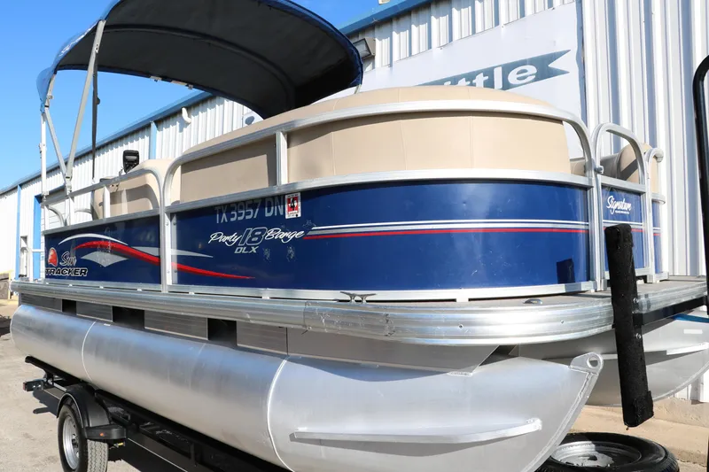 Slide: The Image of 2016 Sun Tracker Party Barge 18 DLX pontoon boat with blue and white exterior. - 13