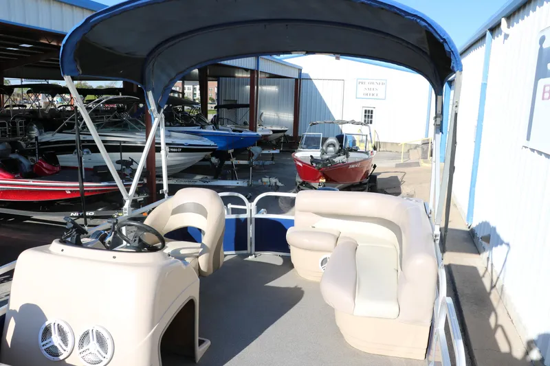 Slide: The Image of 2016 Sun Tracker Party Barge 18 DLX pontoon boat with canopy in a marina. - 19