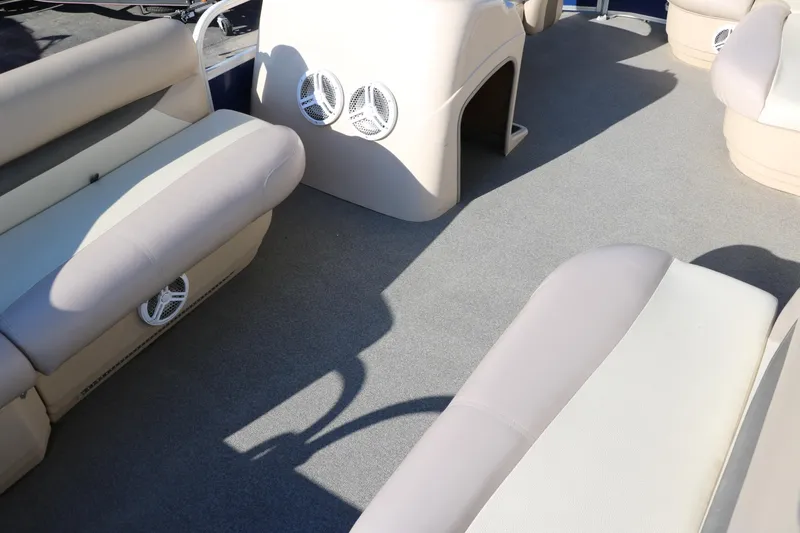 Slide: The Image of 2016 Sun Tracker Party Barge 18 DLX interior with beige seating and carpeted floor. - 20
