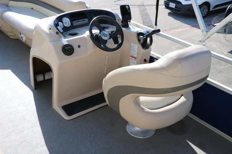 Slide: The Image of 2016 Sun Tracker Party Barge 18 DLX helm with captain's chair and control panel. - 25