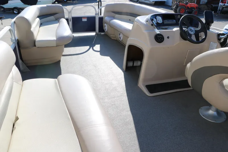 Slide: The Image of 2016 Sun Tracker Party Barge 18 DLX interior with seating and helm. - 26