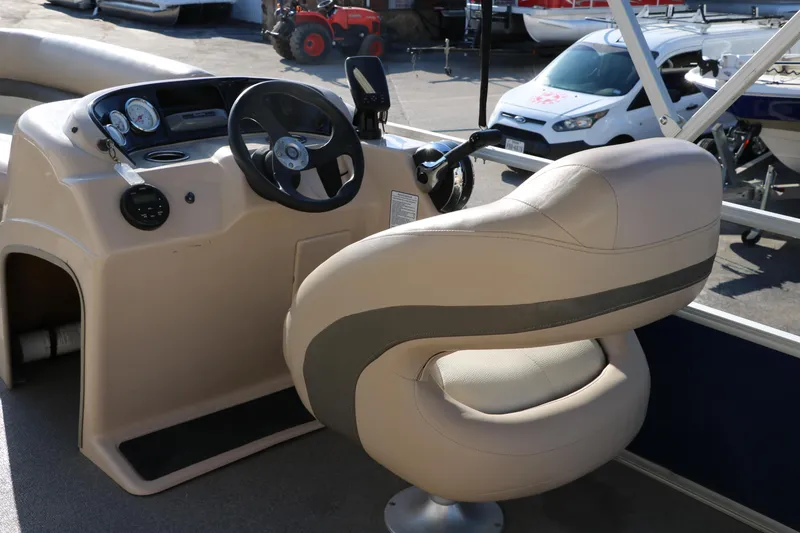 Slide: The Image of 2016 Sun Tracker Party Barge 18 DLX helm with steering wheel and captain's chair. - 27