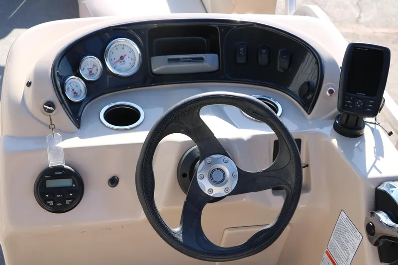 Slide: The Image of 2016 Sun Tracker Party Barge 18 DLX steering console with gauges and controls. - 28