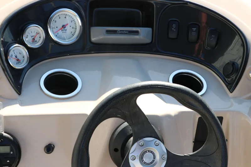 Slide: The Image of 2016 Sun Tracker Party Barge 18 DLX dashboard with steering wheel and gauges. - 30