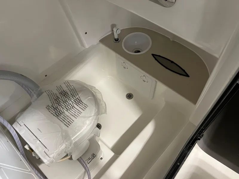 Slide: The Image of 2024 Sea Pro 245 FLX boat interior with sink and toilet. - 10