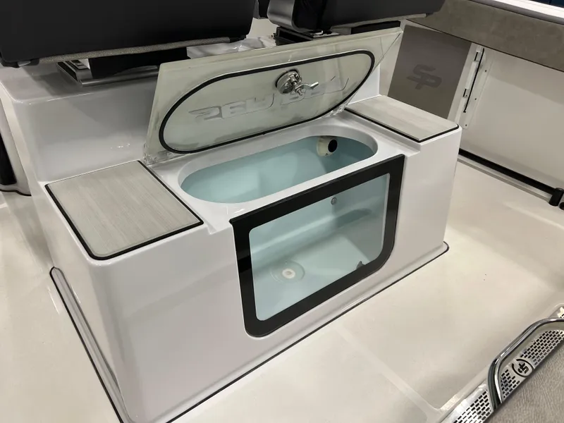 Slide: The Image of 2024 Sea Pro 245 FLX boat livewell with open lid and seating area. - 11