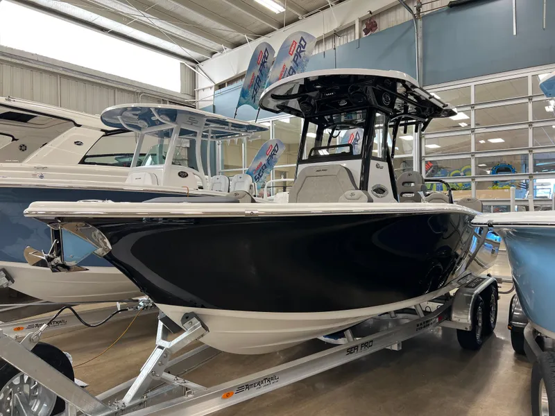 Slide: The Image of 2024 Sea Pro 245 FLX boat on display in a showroom. - 3