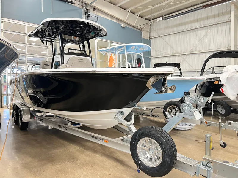 Slide: The Image of 2024 Sea Pro 245 FLX boat on a trailer in a showroom. - 4