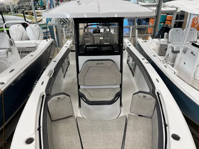 Slide: The Image of 2024 Sea Pro 245 FLX boat interior with cushioned seating and center console. - 6