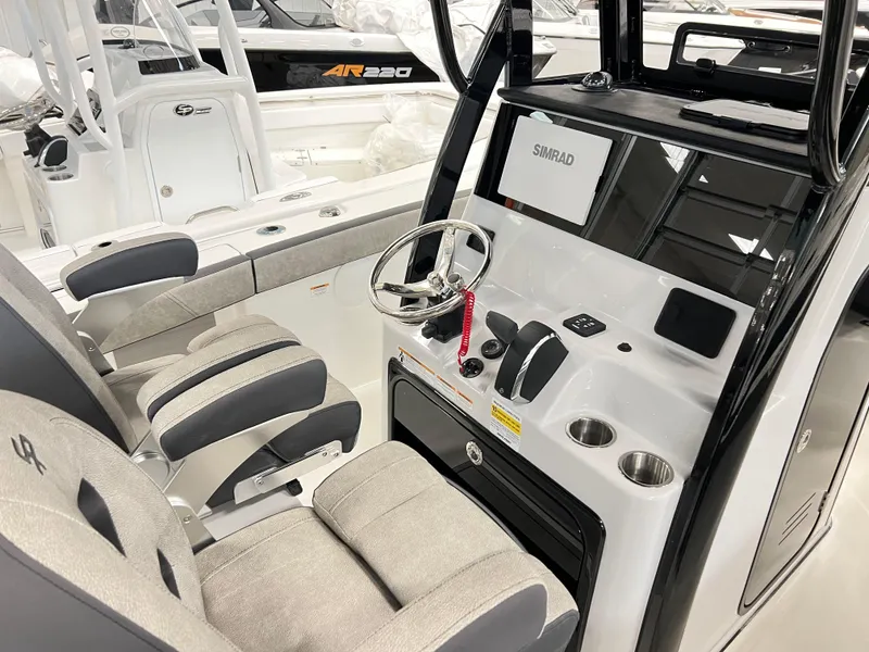 Slide: The Image of 2024 Sea Pro 245 FLX boat interior with steering console and seating. - 7