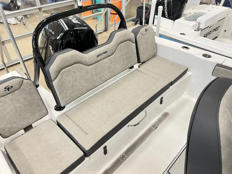 Slide: The Image of 2024 Sea Pro 245 FLX boat interior with cushioned seating and storage compartments. - 9