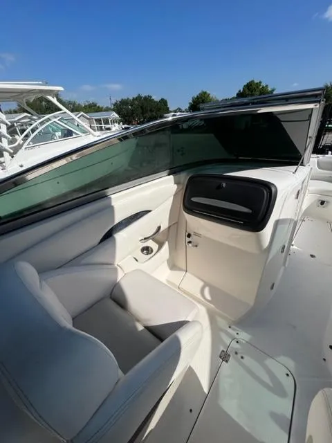 Slide: The Image of 2009 Chaparral 276 SSX boat interior with white seating and dashboard. - 11