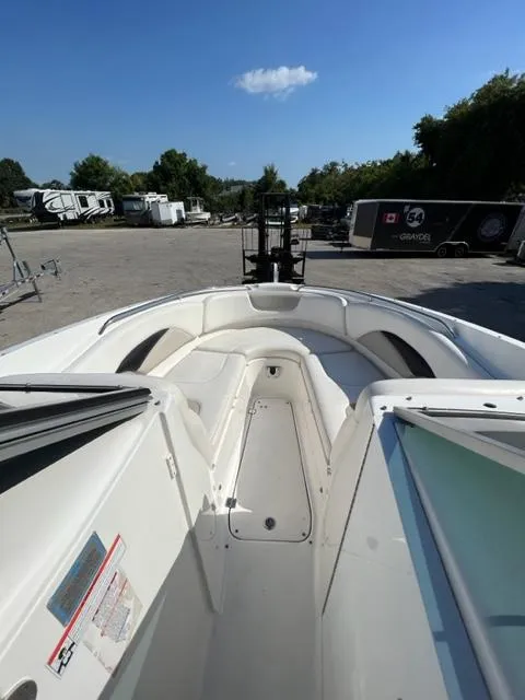 Slide: The Image of 2009 Chaparral 276 SSX boat with white interior, parked outdoors. - 12