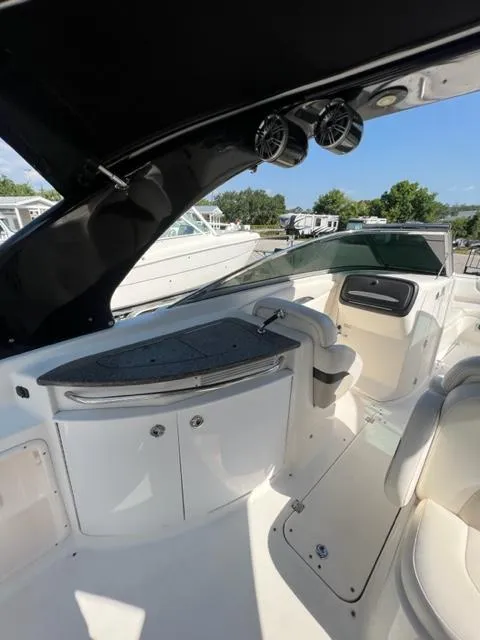 Slide: The Image of 2009 Chaparral 276 SSX boat interior with seating and storage compartments. - 14