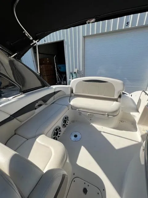 Slide: The Image of 2009 Chaparral 276 SSX boat interior with white seating and speakers. - 15