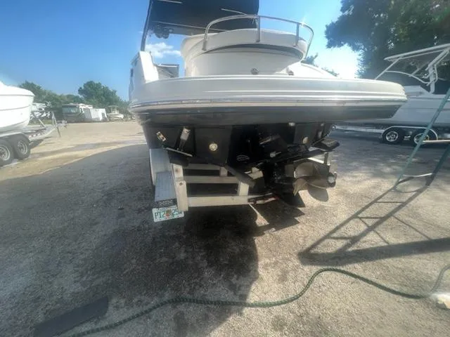 Slide: The Image of 2009 Chaparral 276 SSX boat rear view, parked on a trailer in a marina. - 4