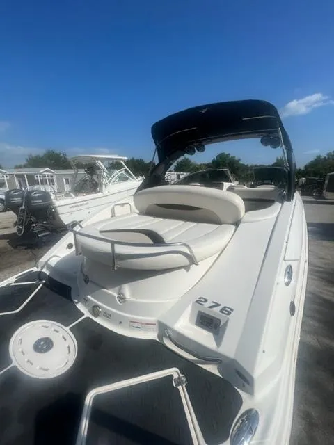 Slide: The Image of 2009 Chaparral 276 SSX boat with white exterior and seating area. - 5