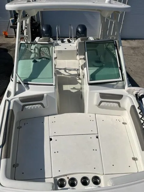 Slide: The Image of 2021 World Cat 230DC dual console boat with open deck and seating. - 10