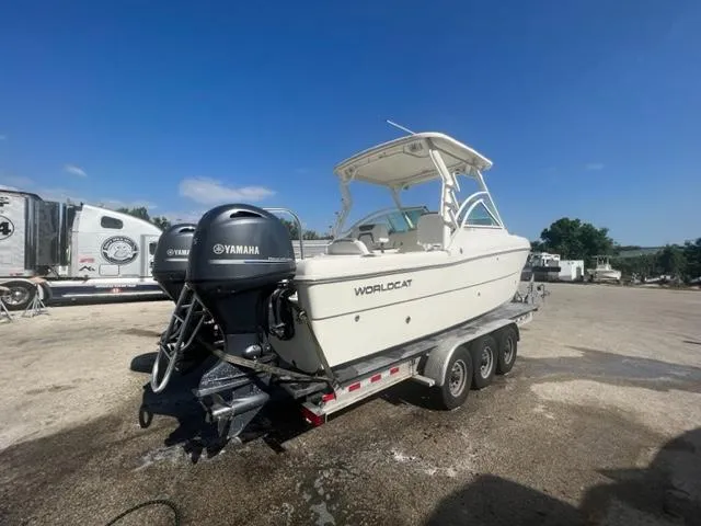 Slide: The Image of 2021 World Cat 230DC boat on a trailer with twin Yamaha outboard engines. - 18