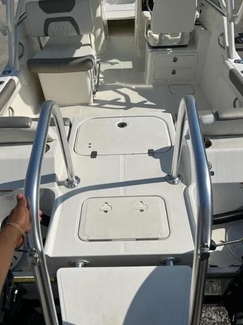 Slide: The Image of 2021 World Cat 230DC boat interior with seating and storage compartments. - 6