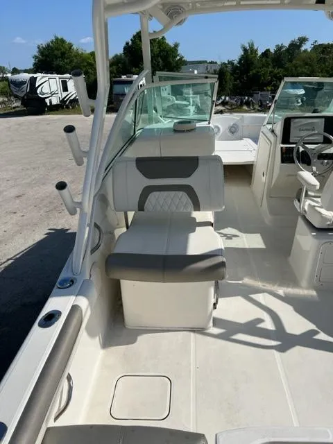 Slide: The Image of 2021 World Cat 230DC boat interior with seating and dashboard. - 7