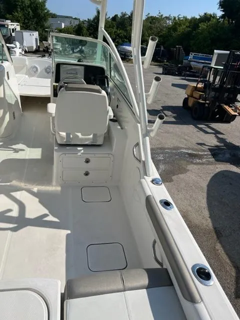 Slide: The Image of 2021 World Cat 230DC boat interior with seating and control console. - 8