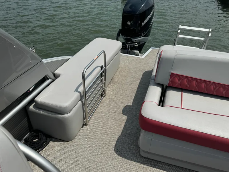 Slide: The Image of 2020 Bennington QSBWAX2SG pontoon boat interior with seating and outboard motor. - 11