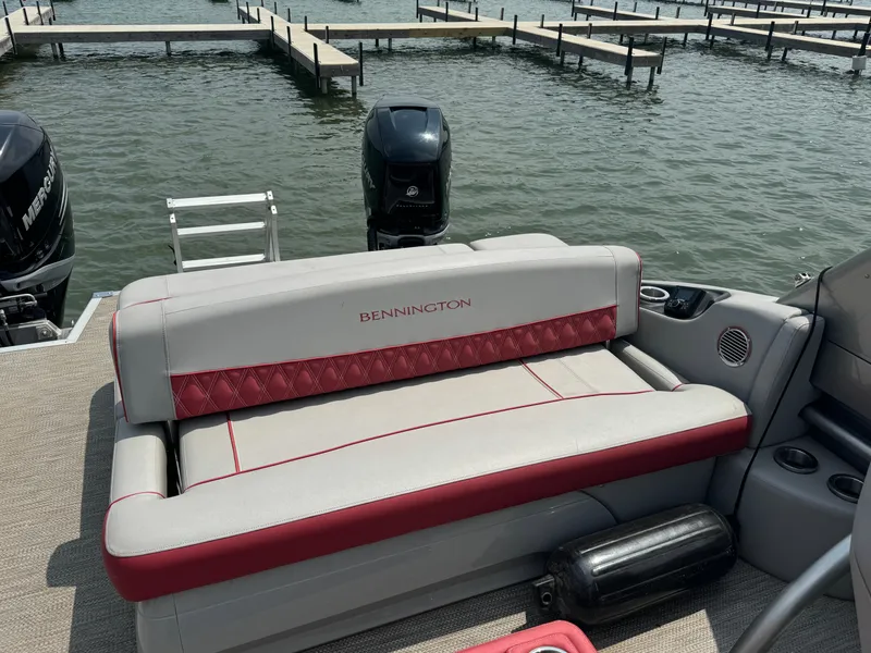 Slide: The Image of 2020 Bennington QSBWAX2SG boat with red and white seating at a dock. - 12