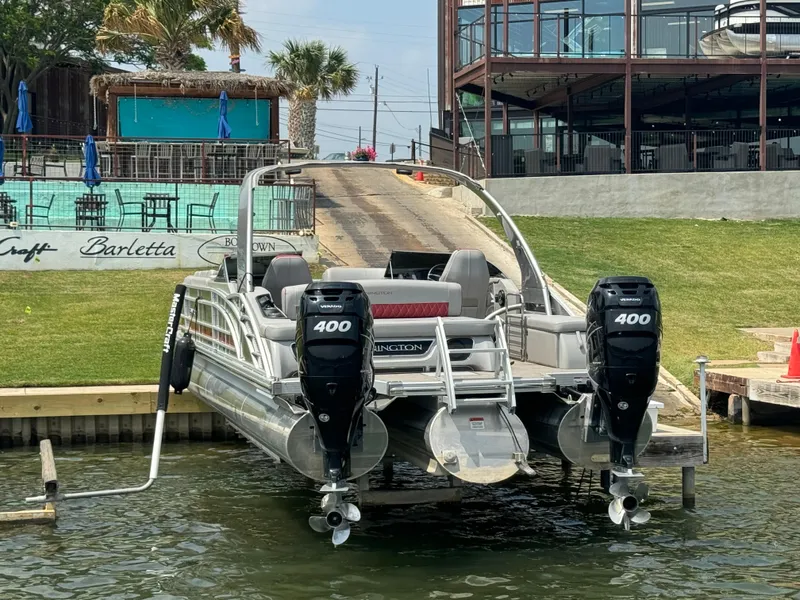 Slide: The Image of 2020 Bennington QSBWAX2SG pontoon boat with twin 400 HP engines docked at a marina. - 15