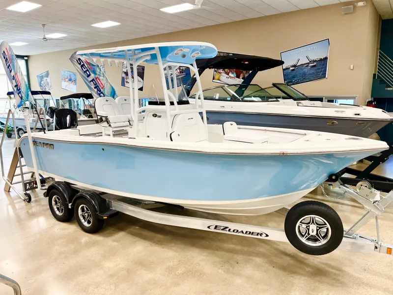 The Image of 2024 Sea Pro 222 Center Console boat on trailer in showroom. - 0