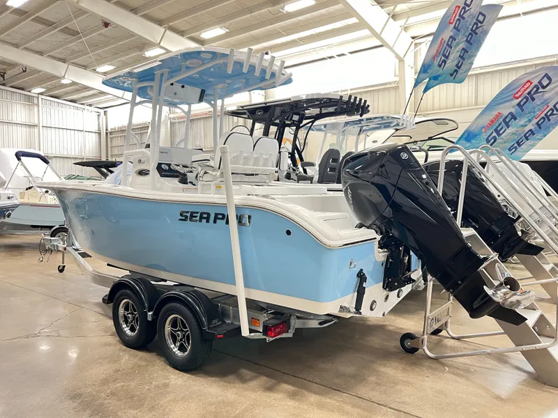 Slide: The Image of 2024 Sea Pro 222 Center Console boat on trailer in showroom. - 2