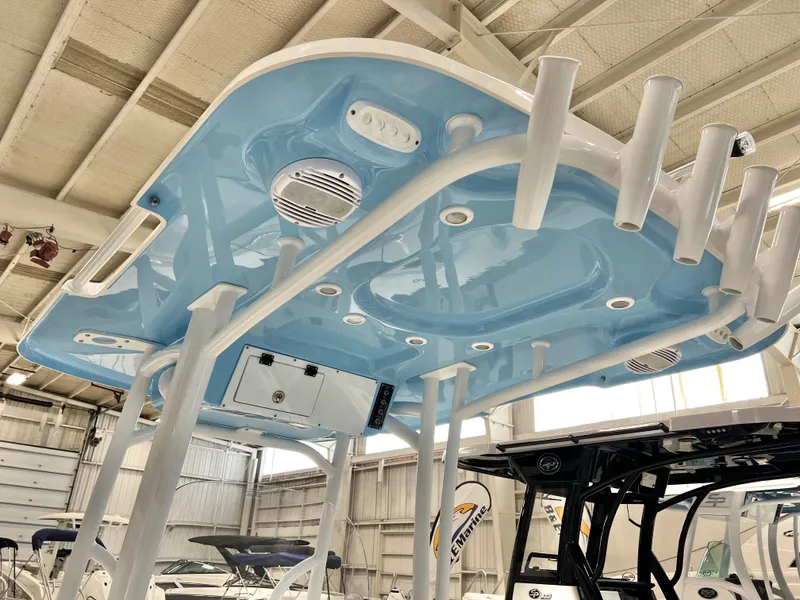 Slide: The Image of 2024 Sea Pro 222 Center Console boat with blue hardtop and rod holders. - 4