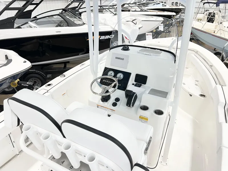 Slide: The Image of 2024 Sea Pro 222 Center Console boat interior with dual seats and control panel. - 5