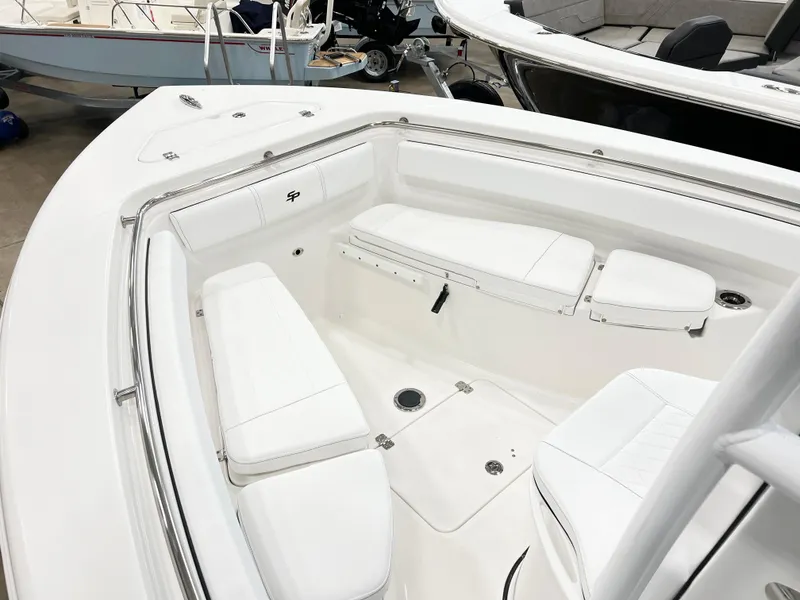 Slide: The Image of 2024 Sea Pro 222 Center Console boat with white cushioned seating in the bow area. - 7