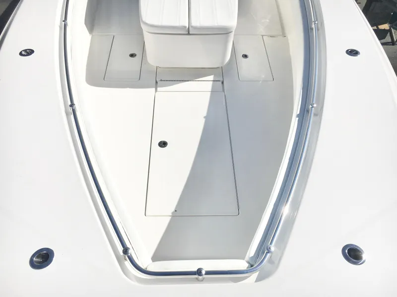 Slide: The Image of 2024 Contender 32 ST boat deck with sleek white finish and seating area. - 12