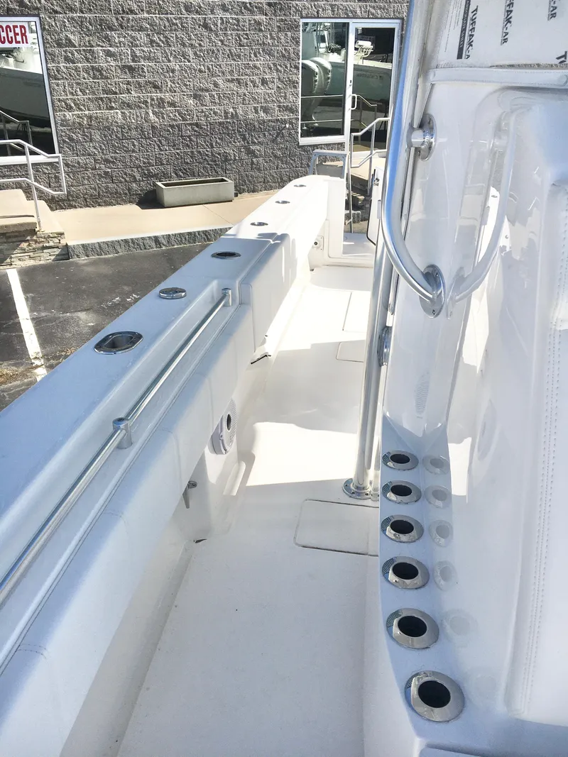 Slide: The Image of 2024 Contender 32 ST boat deck with rod holders and sleek design. - 17