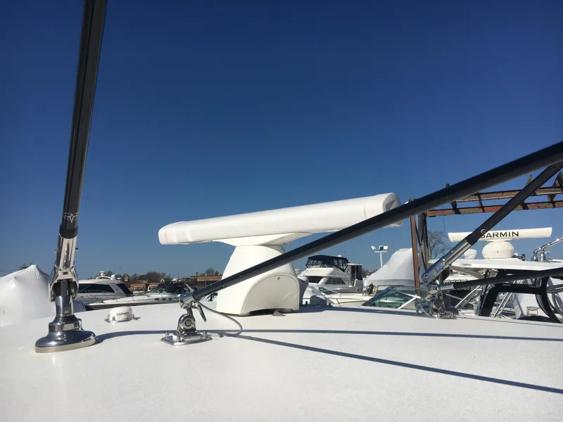 Slide: The Image of 2024 Contender 32 ST boat deck with radar and clear blue sky. - 23