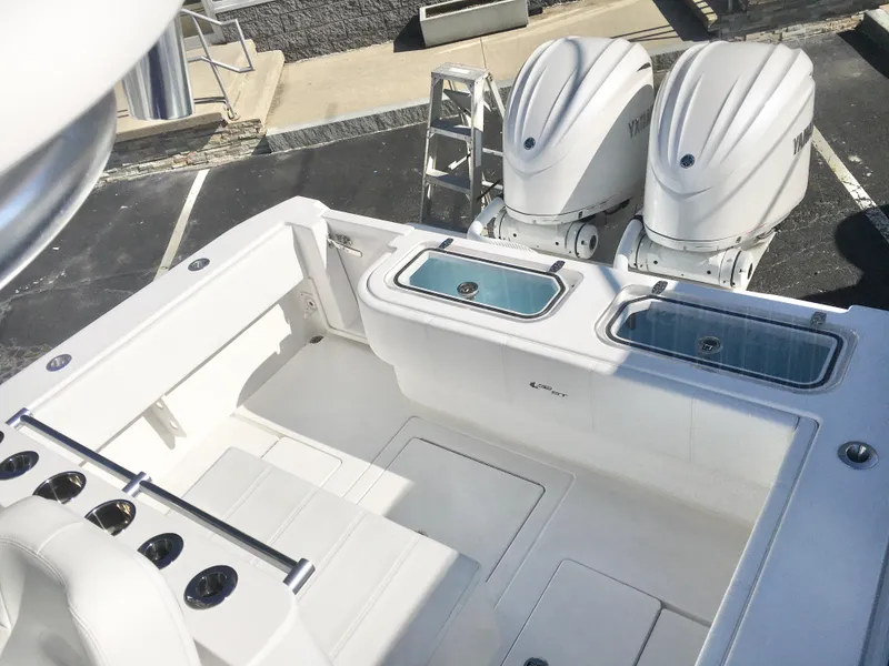 Slide: The Image of 2024 Contender 32 ST boat with dual outboard engines and spacious deck layout. - 24