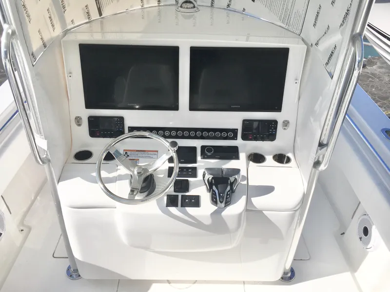 Slide: The Image of 2024 Contender 32 ST boat console with dual screens and steering wheel. - 28